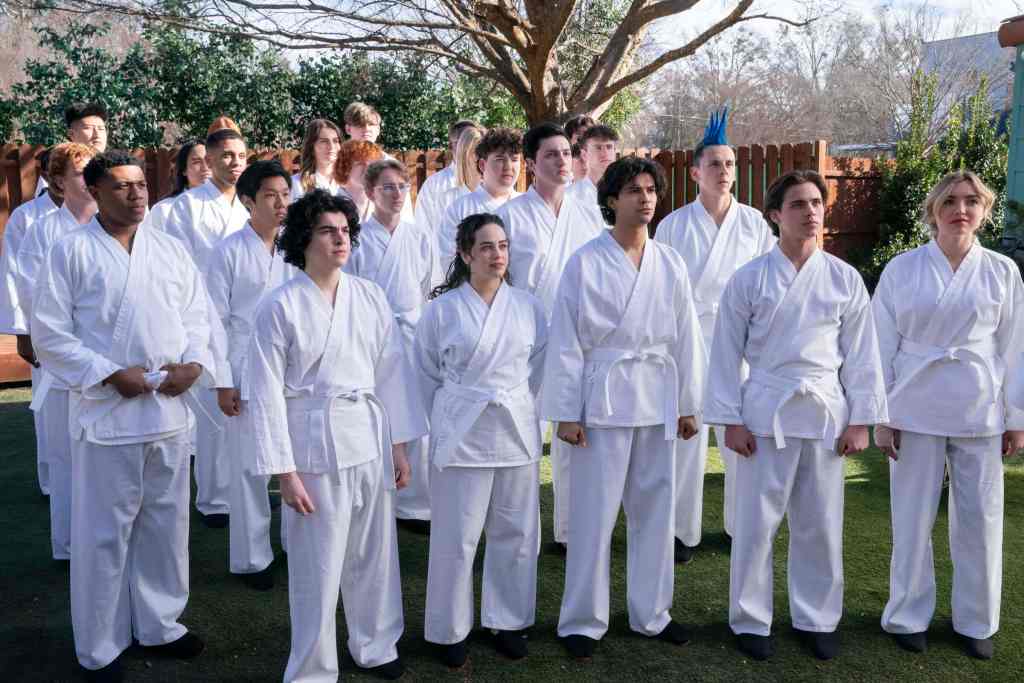 COBRA KAI SEASON 6: FIRST LOOK 2 Cobra Kai. (L to R) Khalil Everage as Chris, Nathaniel Oh as Nate, Griffin Santopeitro as Anthony Larusso, Owen Morgan as Bert, Mary Mouser as Samantha LaRusso, Aedin Mincks as Mitch, Gianni DeCenzo as Demetri, Xolo Maridueña as Miguel Diaz, Jacob Bertrand as Eli 'Hawk' Moskowitz, Tanner Buchanan as Robby Keene, Peyton List as Tory Nichols in Cobra Kai. Cr. Curtis Bonds Baker/Netflix © 2024