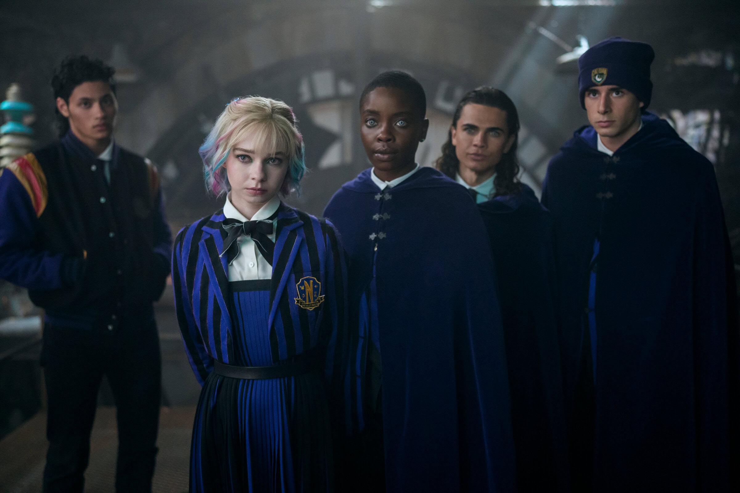 Wednesday. (L to R) Noah B. Taylor as Bruno, Emma Myers as Enid, Joy Sunday as Bianca, Oliver Watson as Kent, Georgie Farmer as Ajax in episode 205 of Wednesday. Cr. Bernard Walsh/Netflix © 2025